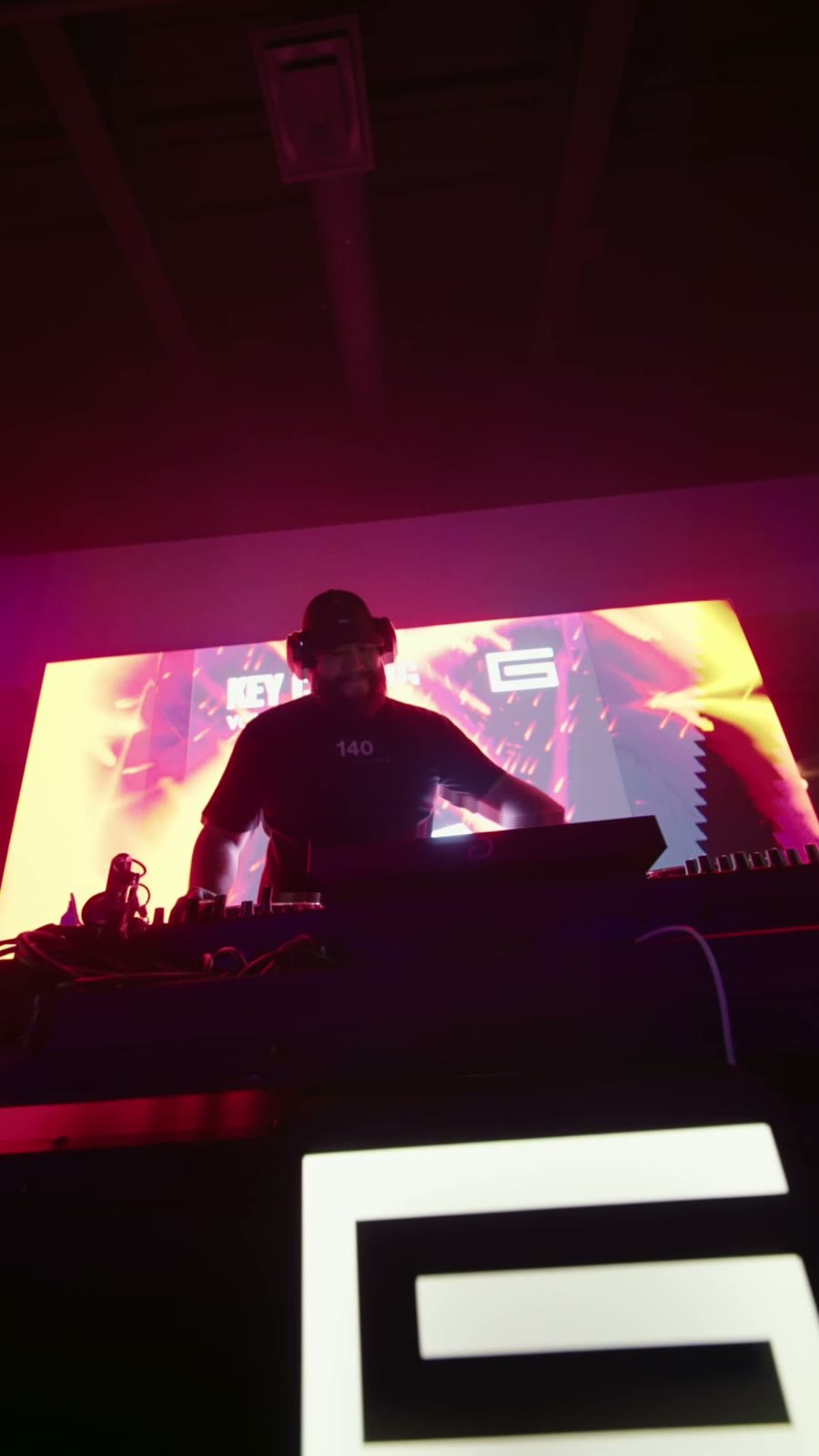 G behind the booth at RÁK afterhours, 2026, with the G mark on its front